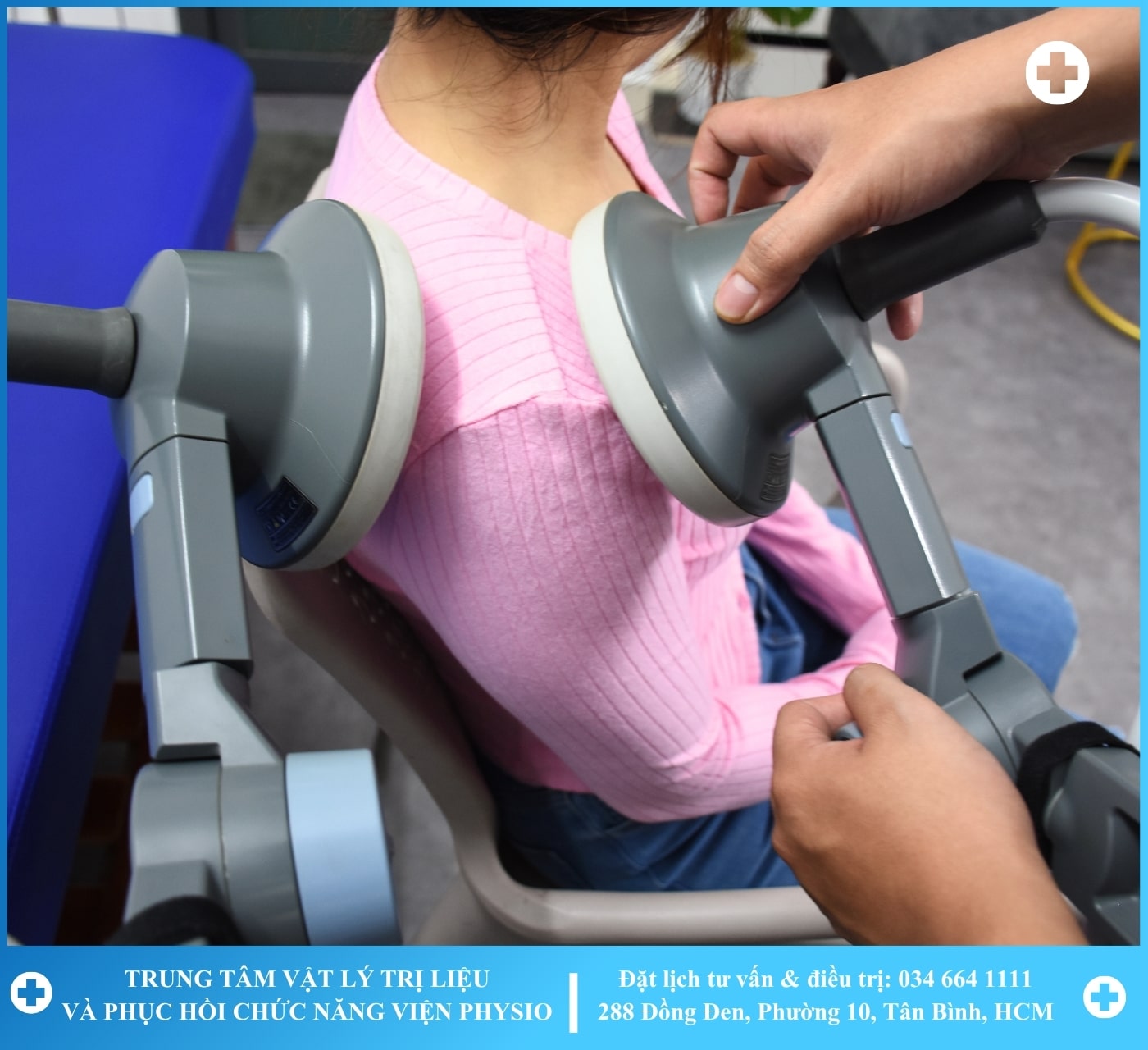 A therapist working with a patient on a rehabilitation machine with greenery in the background