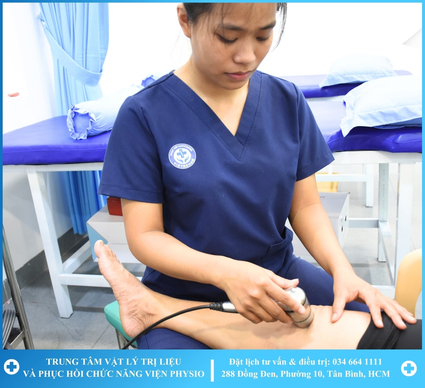 A therapist working with a patient on a rehabilitation machine with greenery in the background