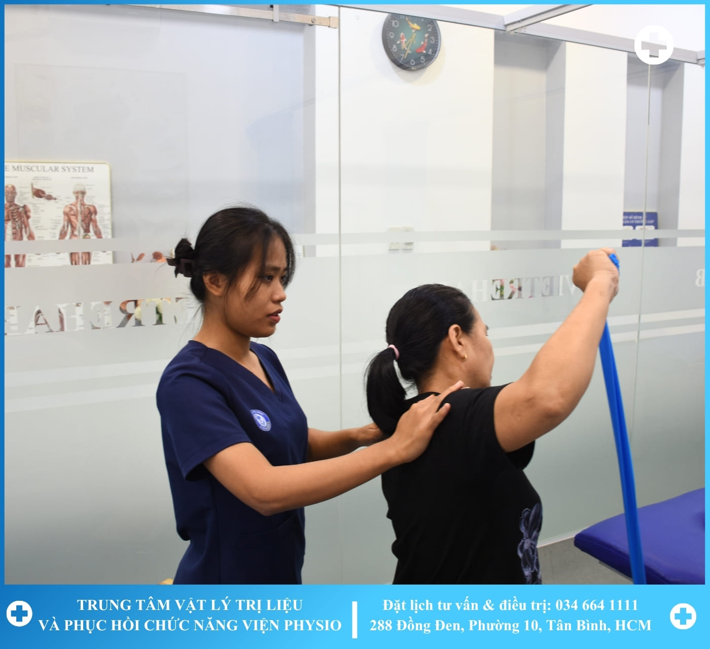 A therapist working with a patient on a rehabilitation machine with greenery in the background